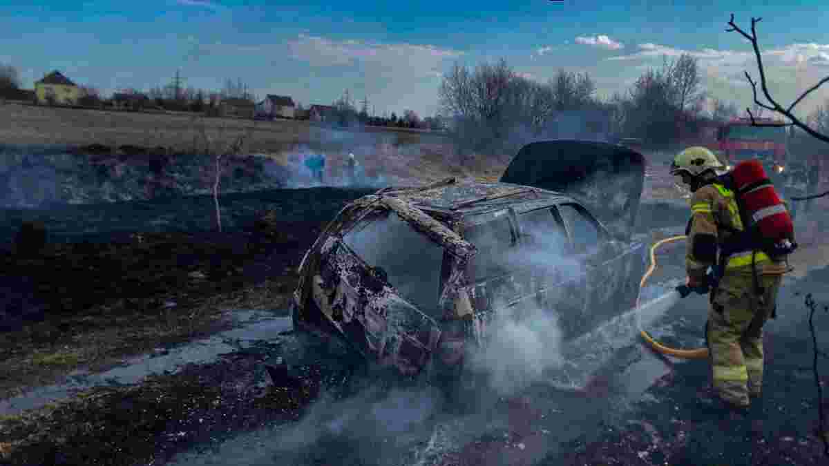 Рятувальник гасить згорілий автомобіль після пожежі в Андалусії, де загинули люди